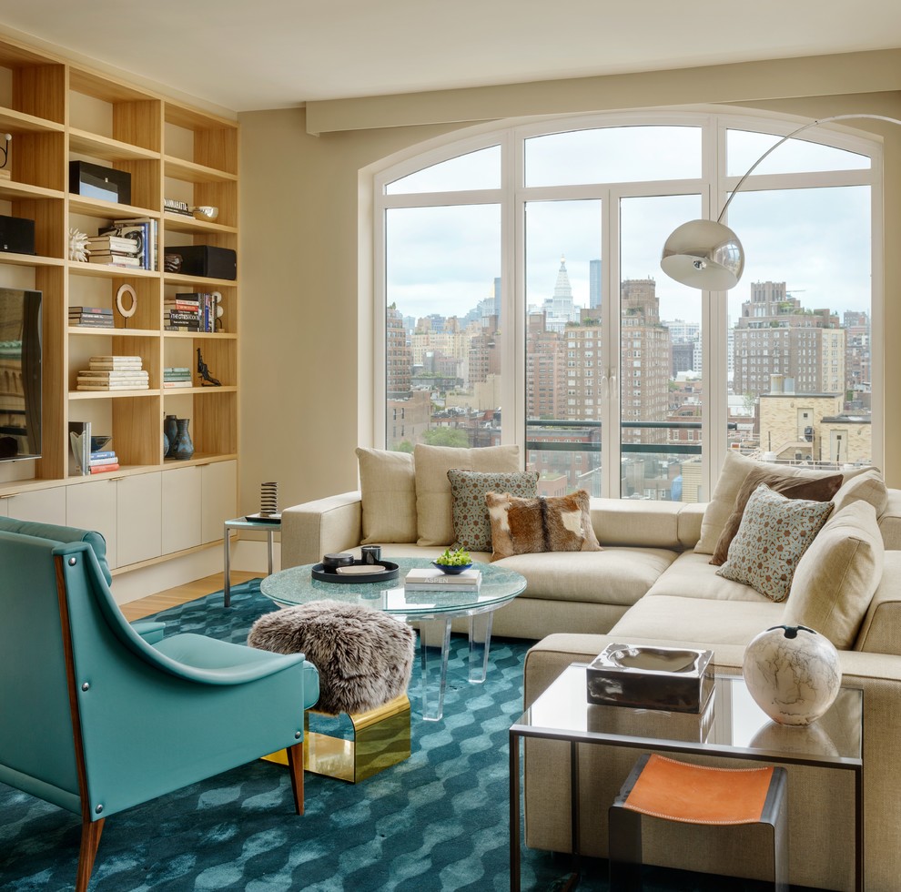 Trendy living room photo in New York with beige walls, no fireplace and a media wall