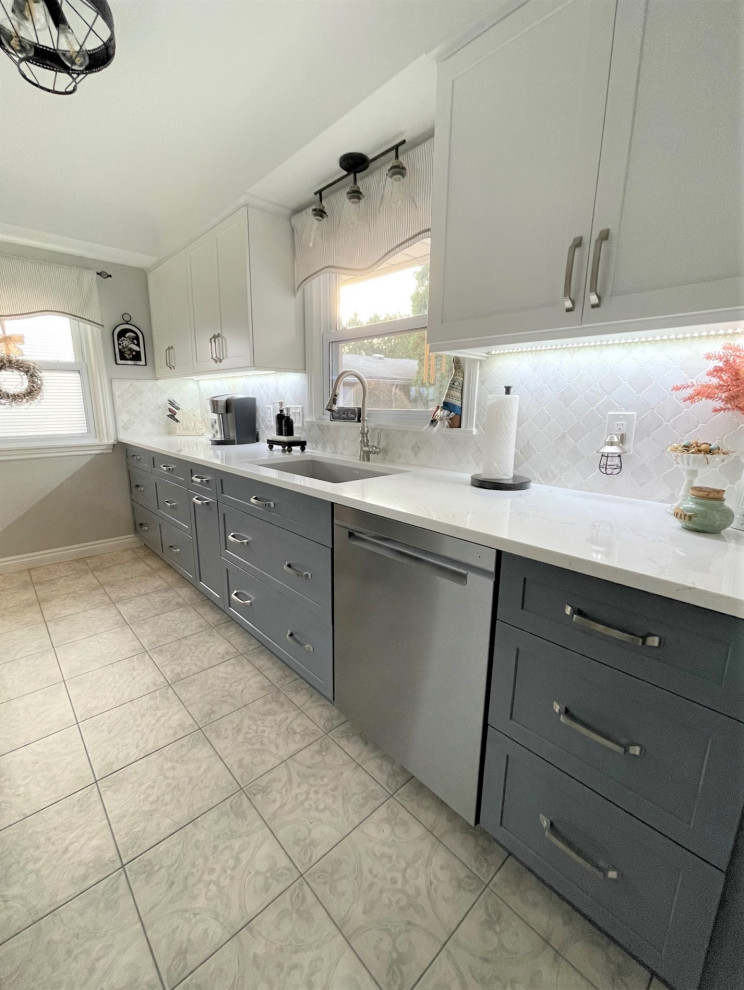 Design ideas for a small galley enclosed kitchen in Detroit with a submerged sink, shaker cabinets, white cabinets, engineered stone countertops, grey splashback, stone tiled splashback, stainless steel appliances, porcelain flooring, no island, grey floors and white worktops.