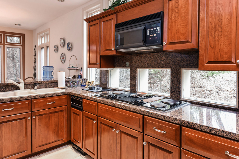 Photo of a large transitional l-shaped eat-in kitchen in Baltimore with a double-bowl sink, raised-panel cabinets, medium wood cabinets, granite benchtops, multi-coloured splashback, stone slab splashback, stainless steel appliances, ceramic floors, with island, white floor and multi-coloured benchtop.