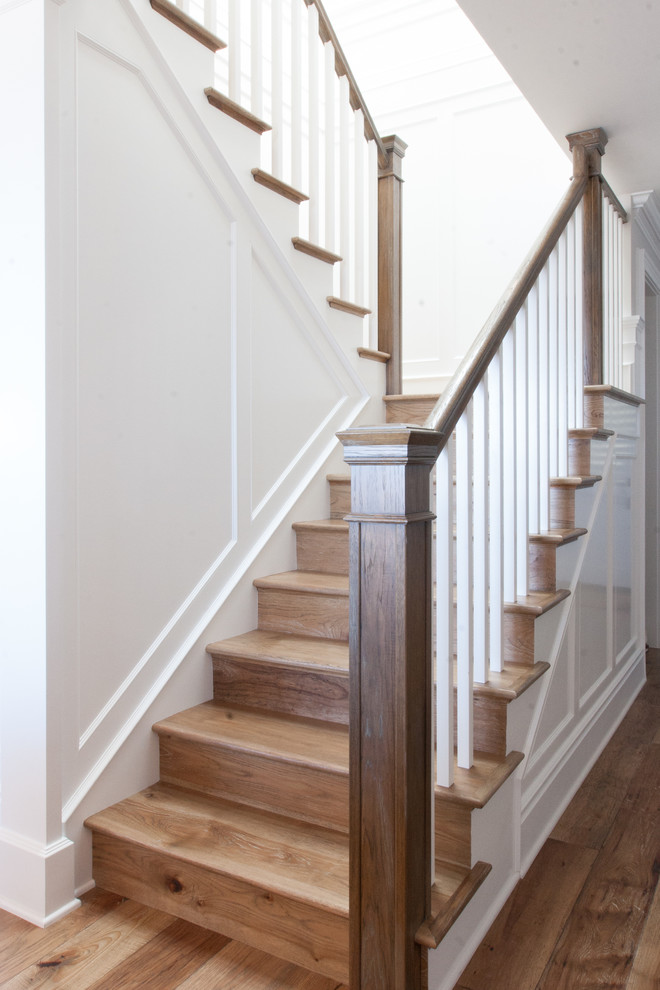 Design ideas for a beach style wood u-shaped staircase in Orange County with wood risers.