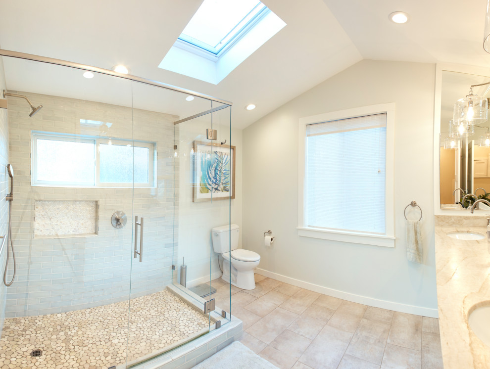 Design ideas for a mid-sized arts and crafts master bathroom in Other with shaker cabinets, white cabinets, a corner shower, a two-piece toilet, blue tile, porcelain tile, blue walls, porcelain floors, an undermount sink, limestone benchtops, brown floor, a hinged shower door and yellow benchtops.