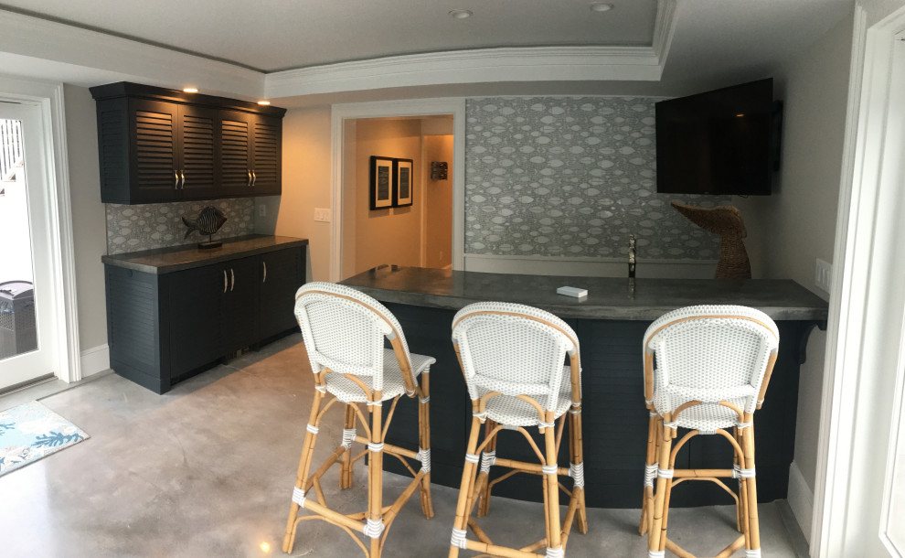 Mid-sized beach style wet bar in Boston with an integrated sink, louvered cabinets, green cabinets, concrete benchtops, porcelain splashback, concrete floors, grey floor and grey benchtop.