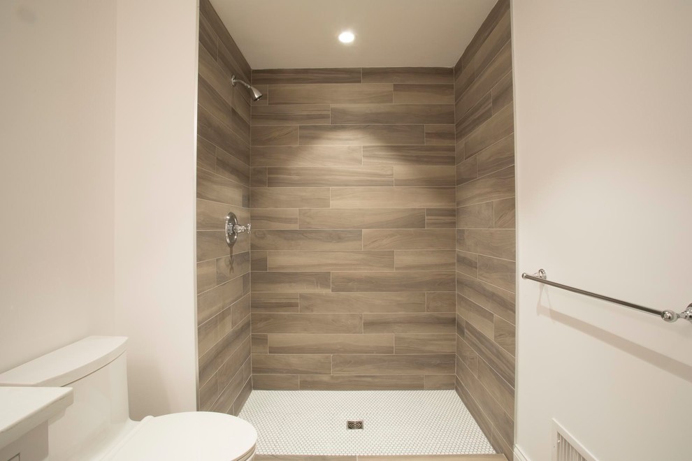 Photo of a small modern 3/4 bathroom in New York with an open shower, brown tile, porcelain tile, grey walls and an open shower.