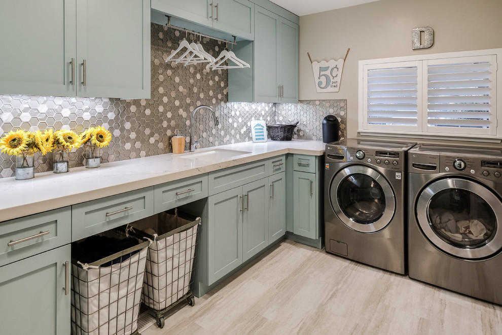 This is an example of a mid-sized midcentury u-shaped utility room in Sacramento with an undermount sink, shaker cabinets, grey cabinets, quartz benchtops, grey walls, porcelain floors, a side-by-side washer and dryer, beige floor and white benchtop.