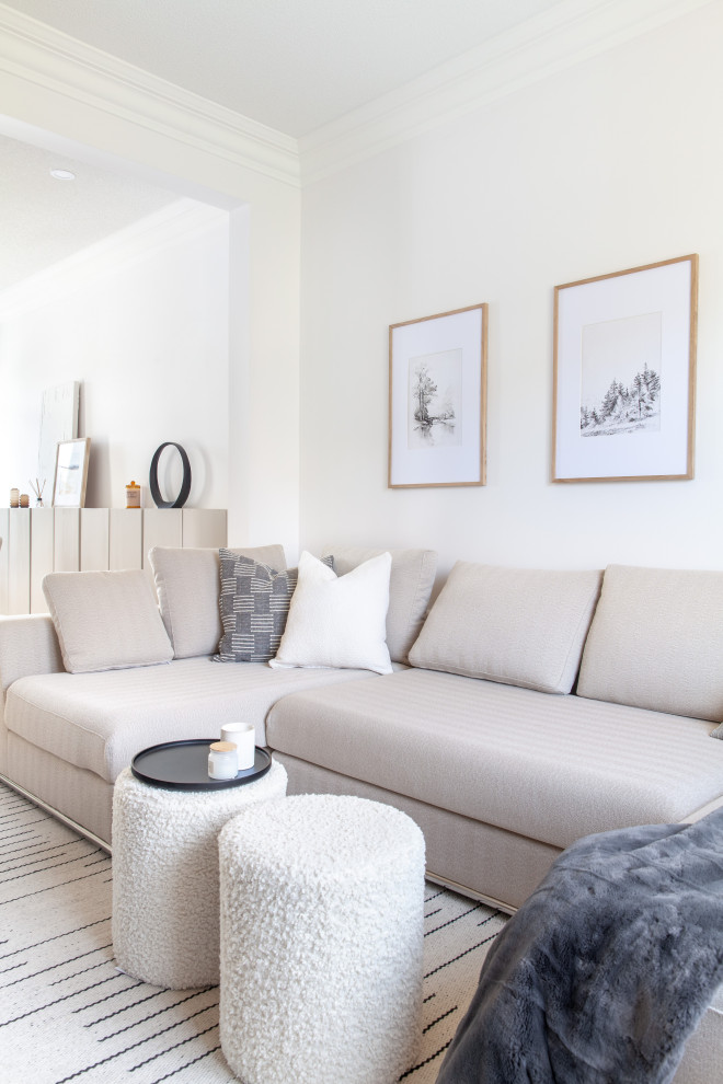 Mid-sized scandinavian family room in Toronto with white walls and light hardwood floors.