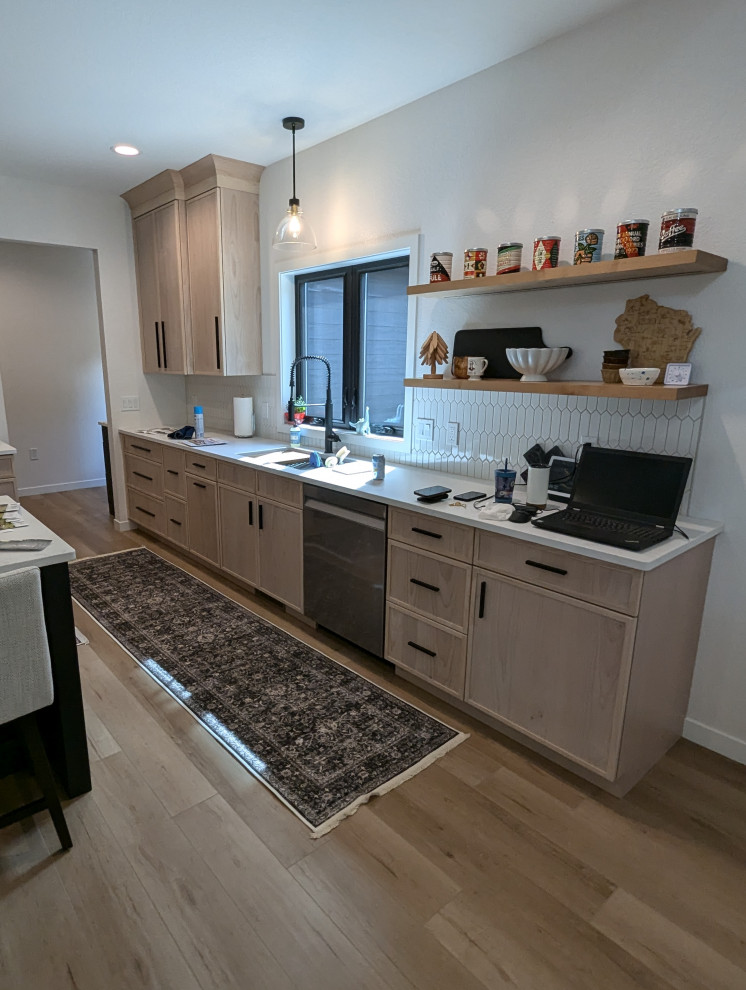 Large transitional l-shaped vinyl floor and brown floor eat-in kitchen photo with a double-bowl sink, shaker cabinets, light wood cabinets, quartzite countertops, white backsplash, ceramic backsplash, stainless steel appliances, an island and white countertops