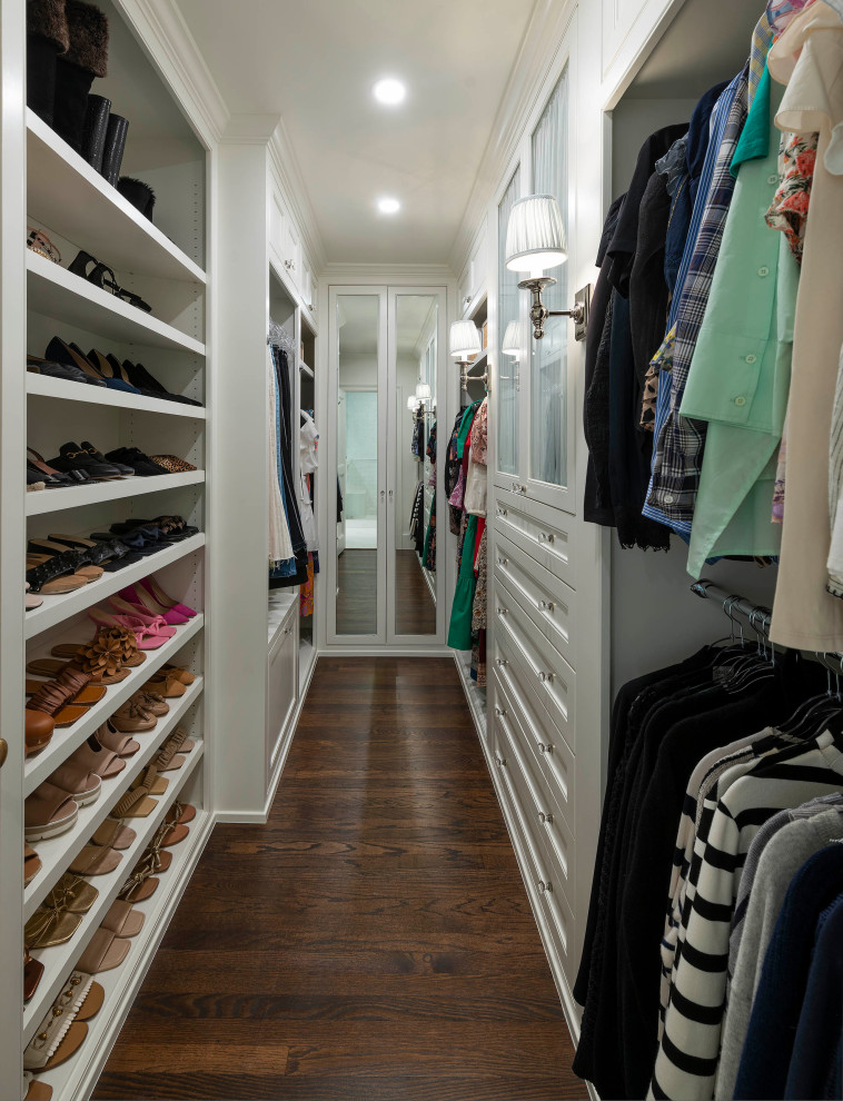 This is an example of a small traditional gender neutral walk-in wardrobe in Dallas with beaded cabinets, white cabinets, medium hardwood flooring and brown floors.