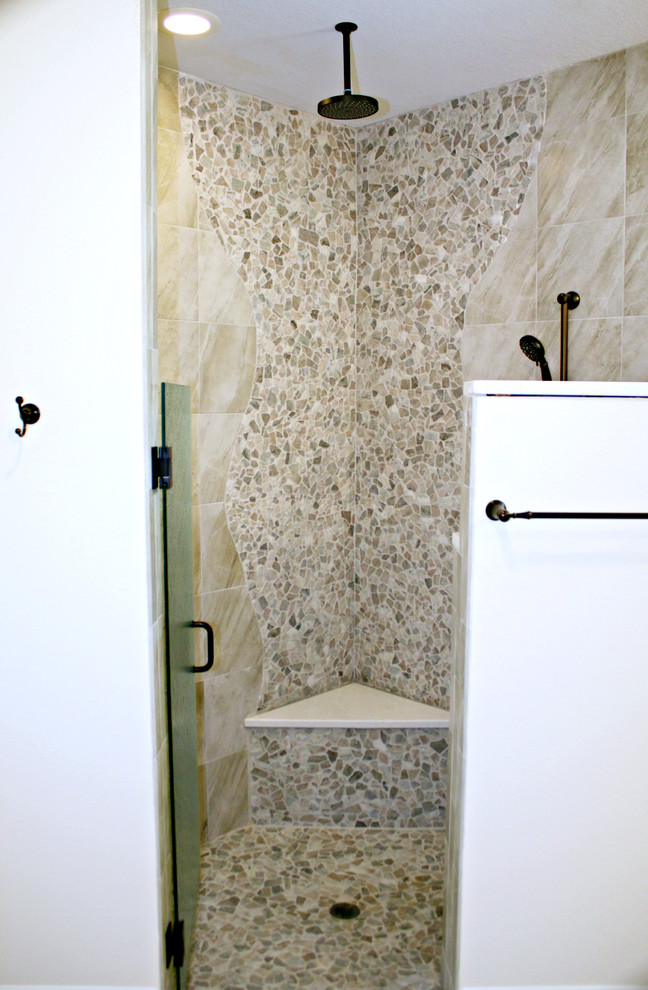 Inspiration for a contemporary bathroom in Tampa with a corner shower, beige tile, pebble tile and a hinged shower door.