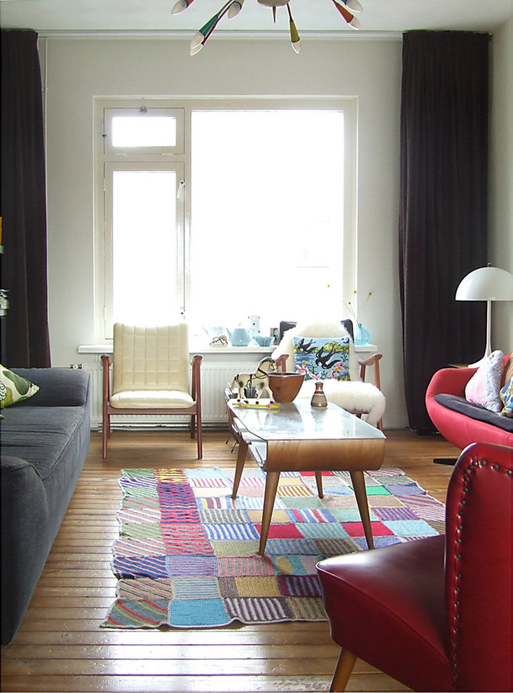 Photo of an eclectic living room in Amsterdam with medium hardwood floors.