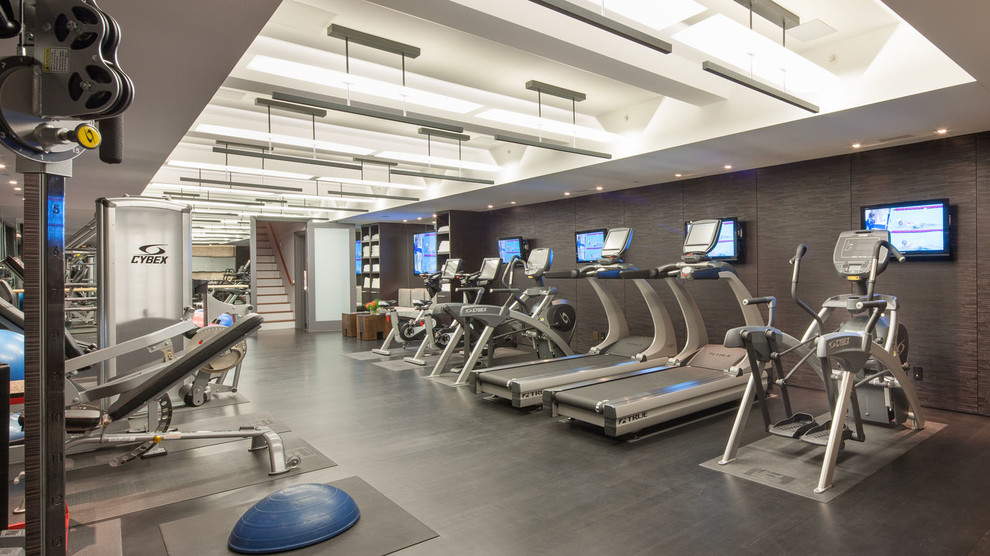 Expansive contemporary home weight room in Boston with grey walls, vinyl floors and black floor.