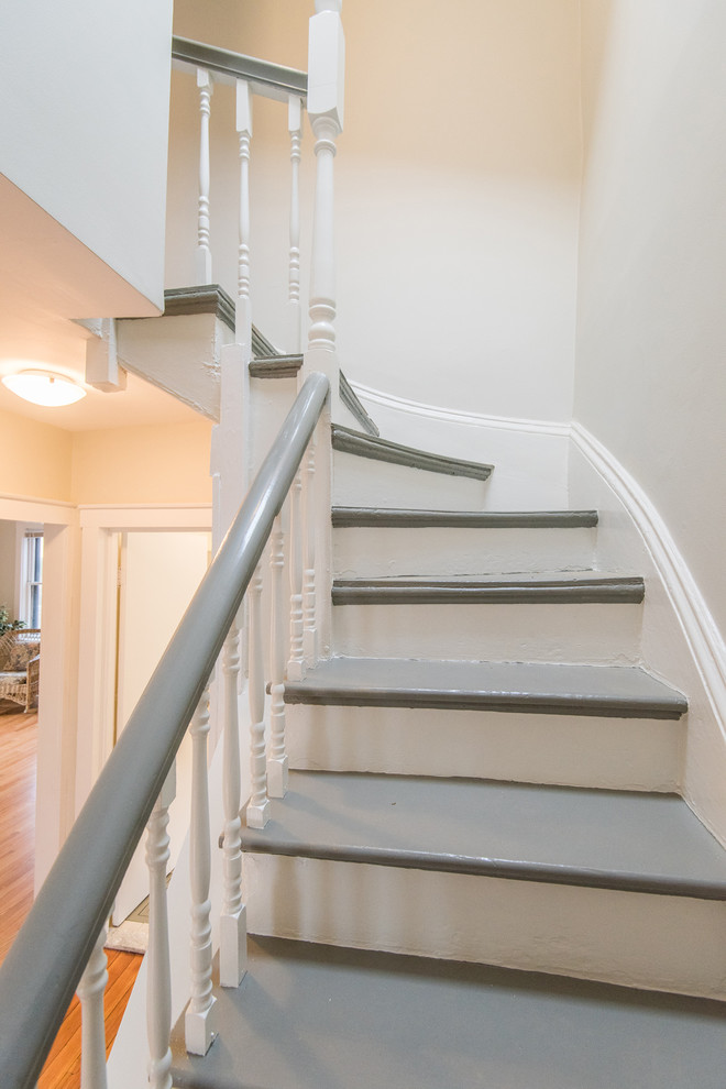 Photo of a mid-sized traditional painted wood curved staircase in Boston with painted wood risers and wood railing.