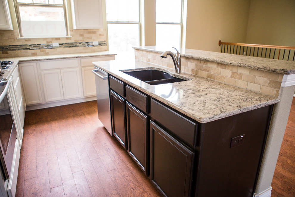 Inspiration for a mid-sized transitional l-shaped medium tone wood floor eat-in kitchen remodel in Austin with an undermount sink, recessed-panel cabinets, white cabinets, granite countertops, beige backsplash, stone tile backsplash, stainless steel appliances and an island