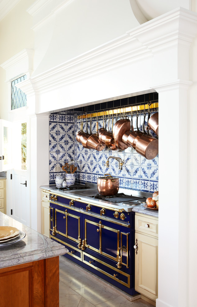 Photo of a large traditional kitchen in San Francisco with recessed-panel cabinets, beige cabinets, marble benchtops, blue splashback, coloured appliances and marble floors.