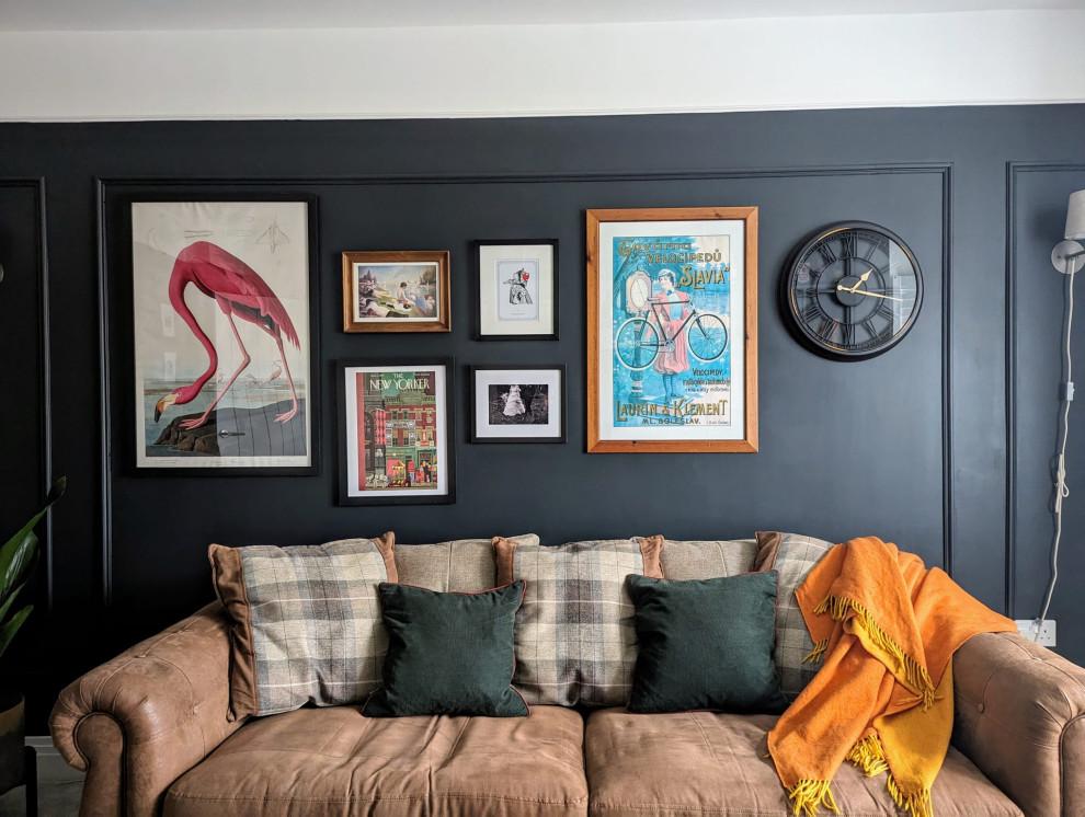 Medium sized eclectic formal and grey and brown enclosed living room feature wall in London with black walls, carpet, a wall mounted tv, beige floors and wainscoting.