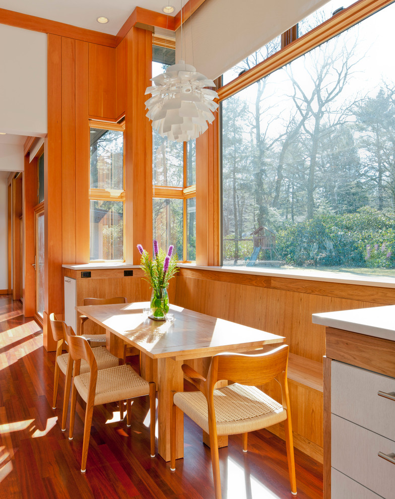 This is an example of a contemporary dining room in Boston with medium hardwood floors.