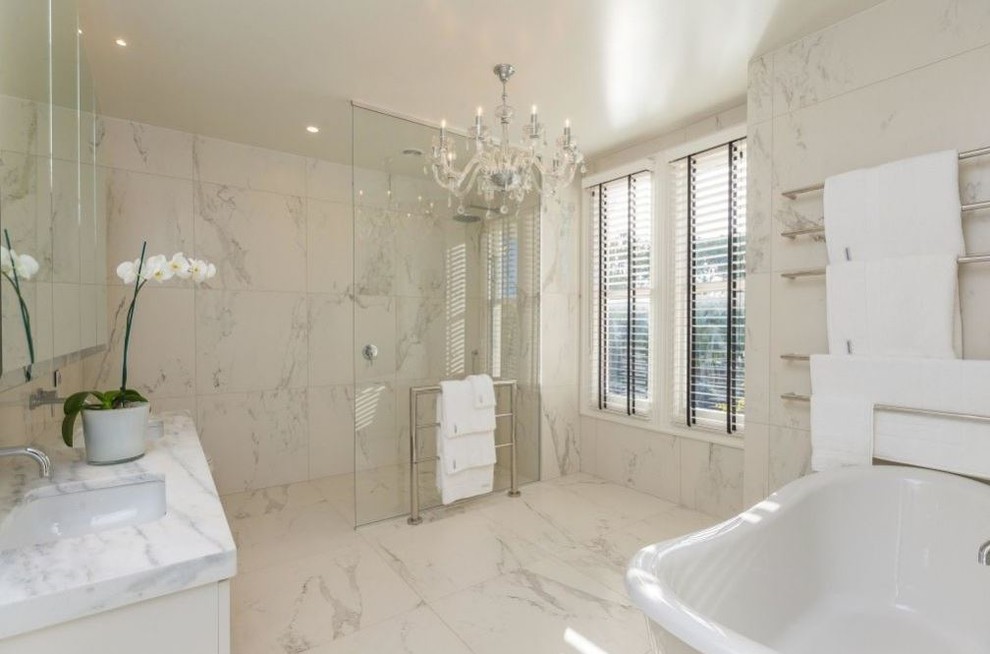 Design ideas for a contemporary bathroom in Auckland with marble floors and marble benchtops.