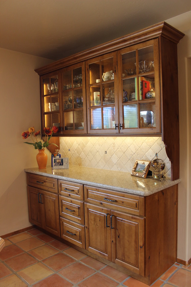 Example of a huge eclectic u-shaped ceramic tile eat-in kitchen design in Phoenix with a farmhouse sink, raised-panel cabinets, brown cabinets, quartz countertops, beige backsplash, stone tile backsplash, stainless steel appliances and a peninsula
