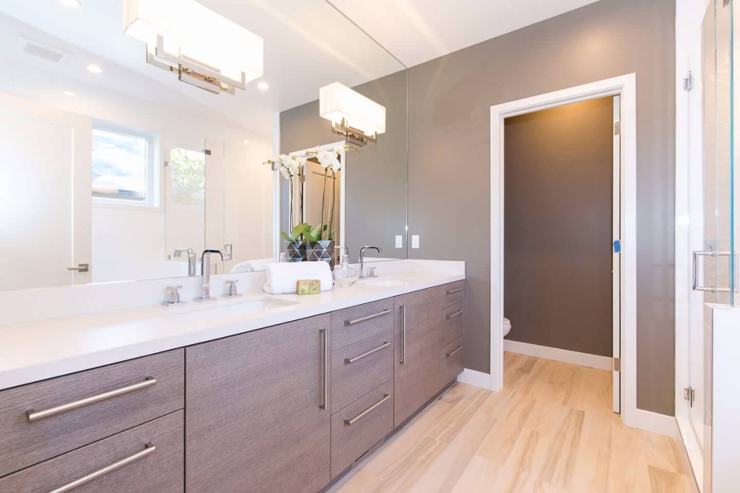 Large minimalist master light wood floor and brown floor bathroom photo in San Francisco with flat-panel cabinets, dark wood cabinets, brown walls, an undermount sink and quartz countertops