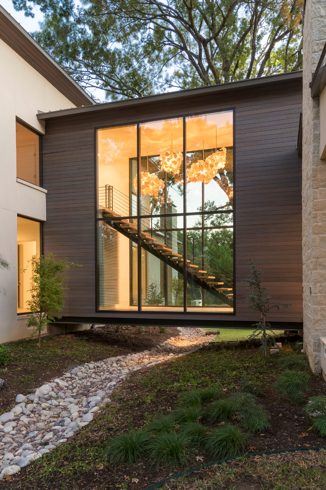 Inspiration for a large contemporary two-storey beige exterior in Dallas with mixed siding.