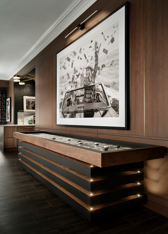 Basement - large transitional walk-out dark wood floor, brown floor and wood wall basement idea in Denver with brown walls, a corner fireplace and a stone fireplace