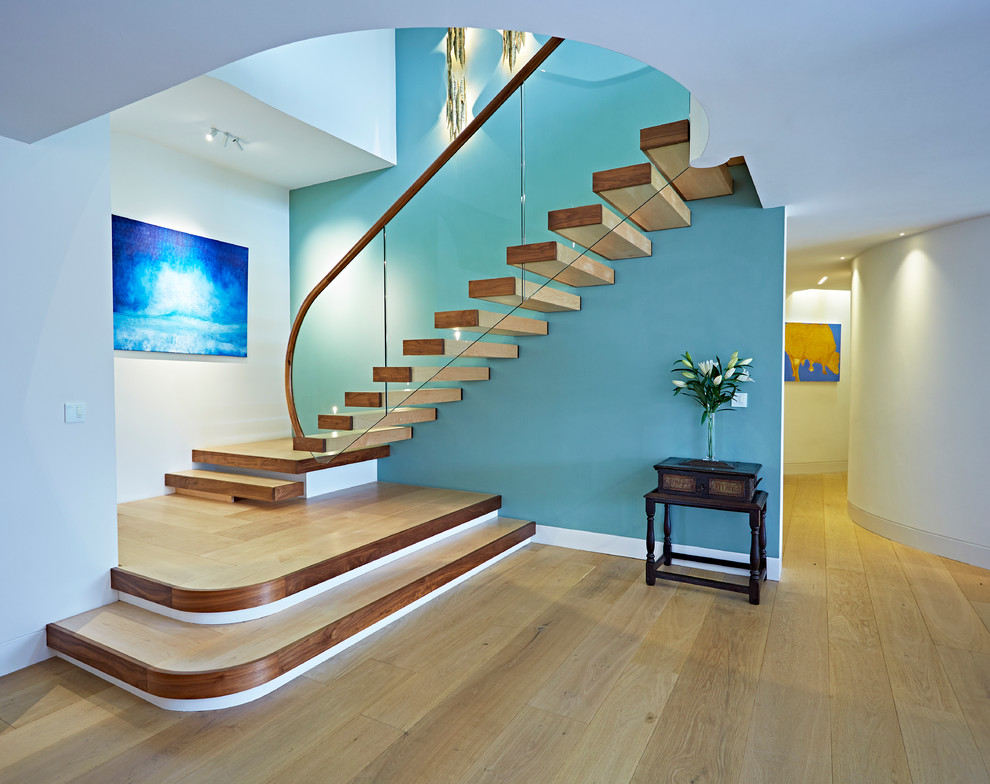 This is an example of a modern wood l-shaped staircase in Devon with open risers.