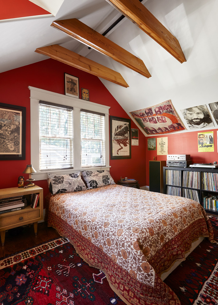 Mediterranean guest bedroom in Nashville with red walls, medium hardwood floors and brown floor.