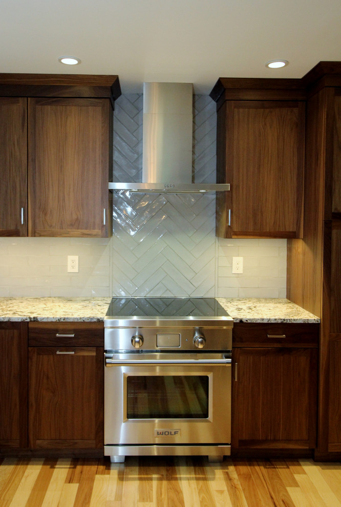 Inspiration for a mid-sized transitional l-shaped kitchen remodel with shaker cabinets, dark wood cabinets, ceramic backsplash, stainless steel appliances, an island and multicolored countertops