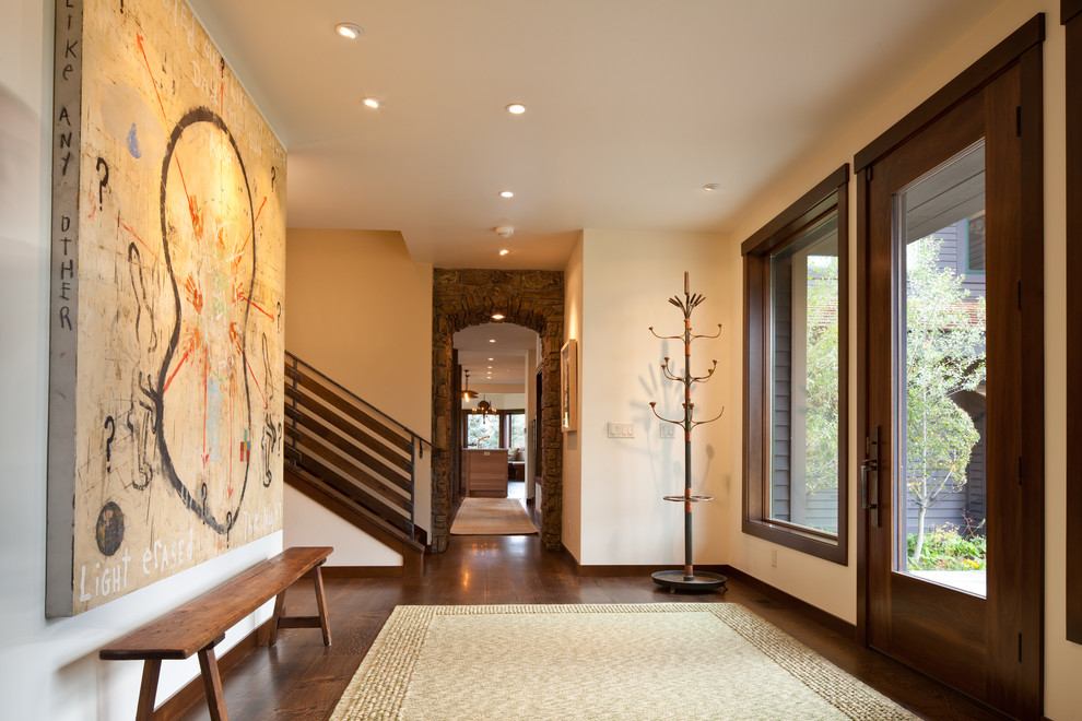 Design ideas for a contemporary entryway in Denver with beige walls and dark hardwood floors.