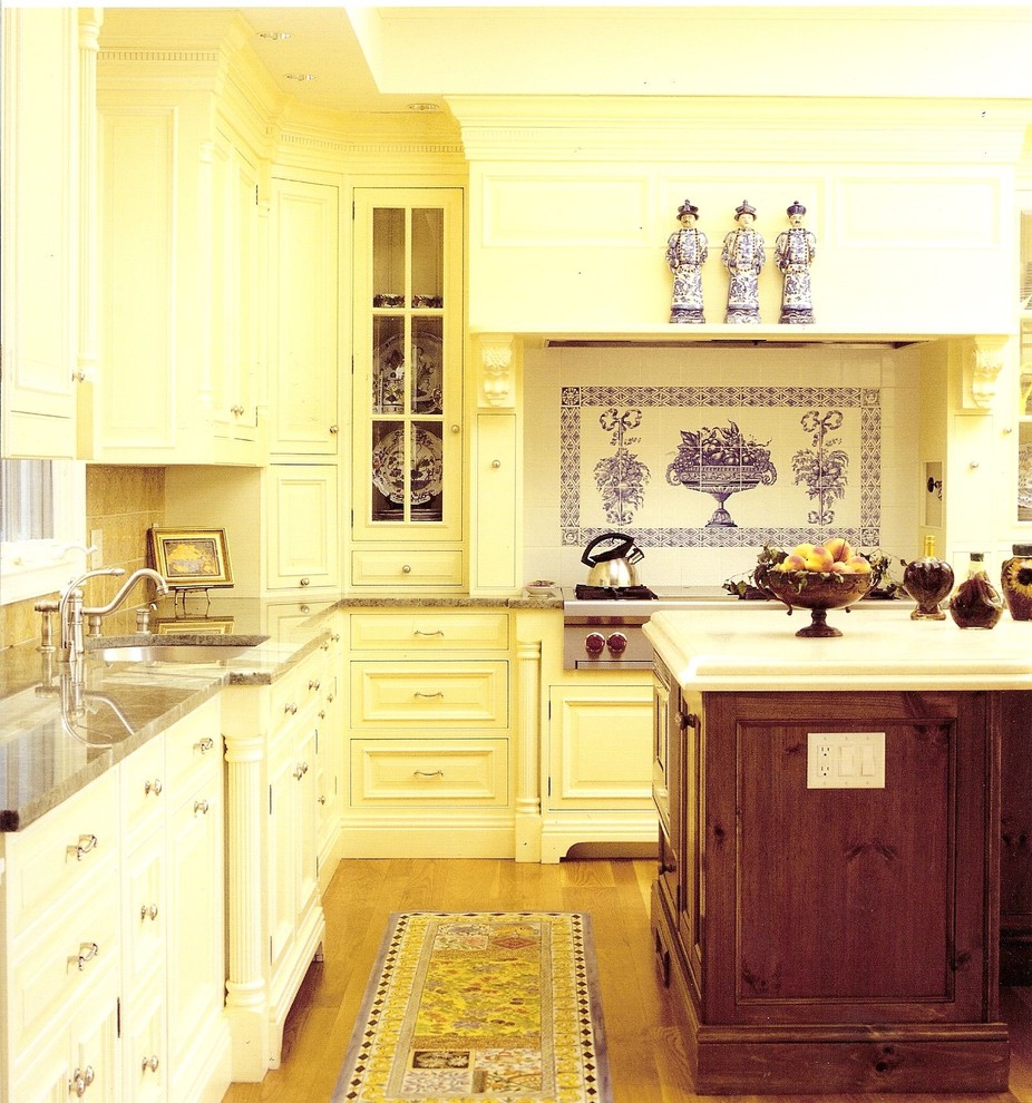 Photo of a large traditional kitchen in Bridgeport with glass-front cabinets, a single-bowl sink, yellow cabinets and with island.