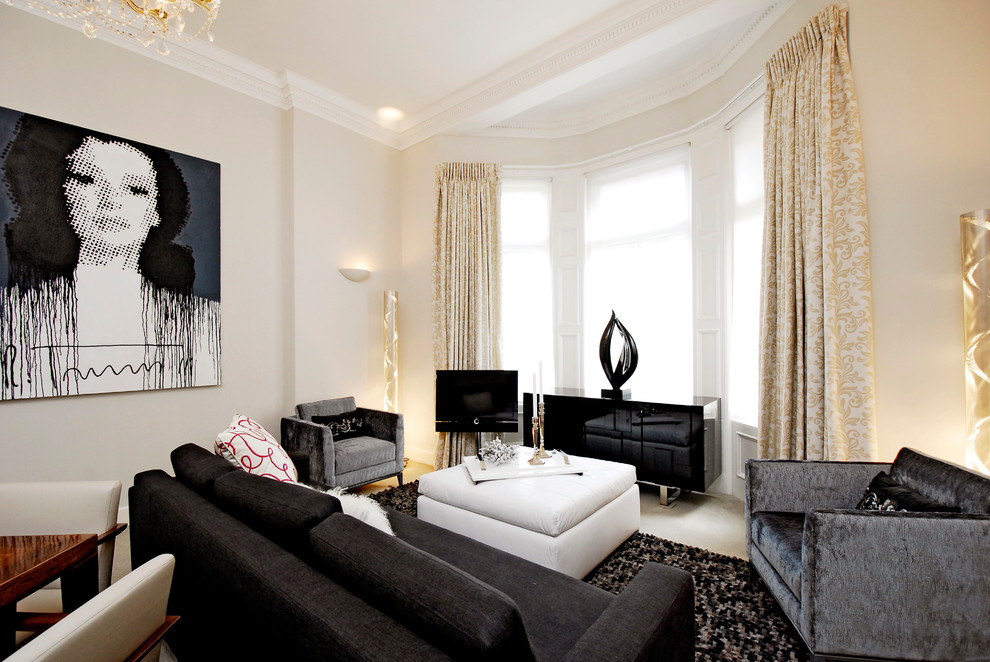 Transitional open concept living room in London with beige walls, carpet and a freestanding tv.