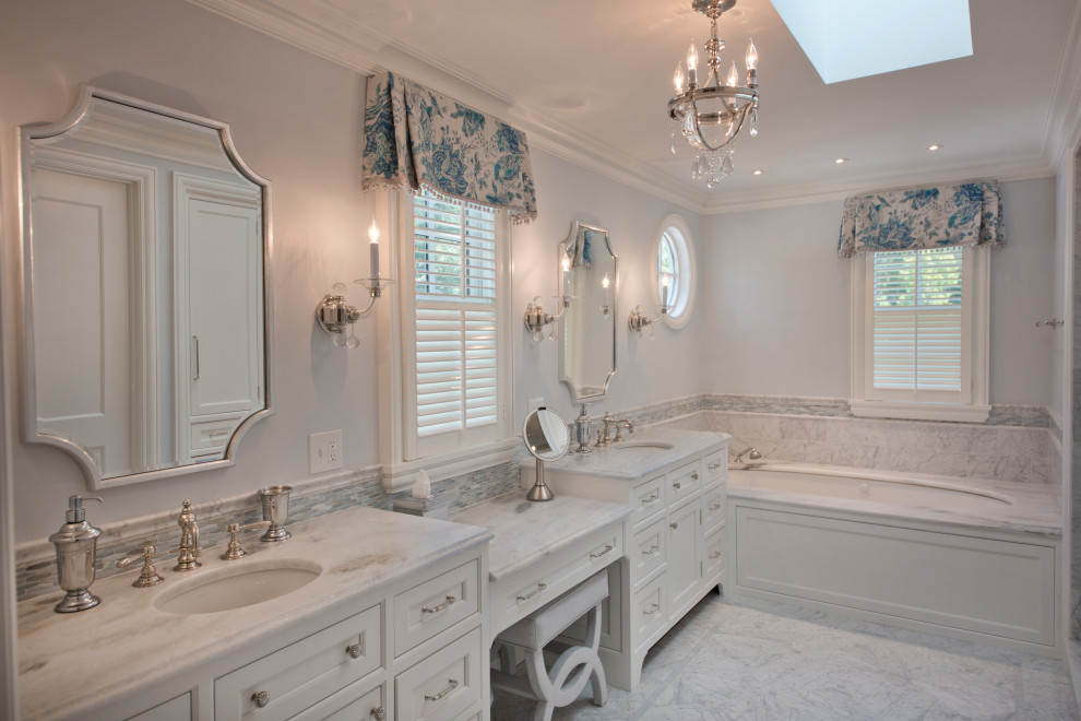 Inspiration for a large traditional master bathroom with beaded inset cabinets, white cabinets, an undermount tub, gray tile, blue walls, an undermount sink, grey floor, grey benchtops, a double vanity and a built-in vanity.