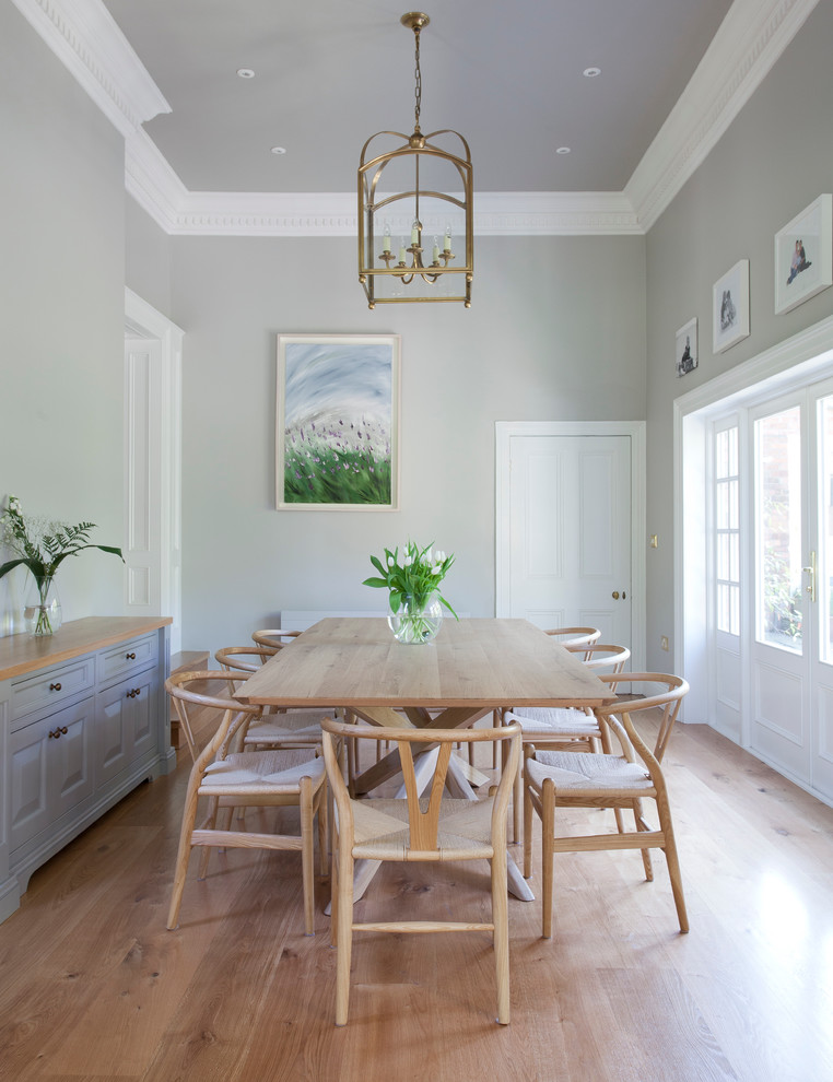 Design ideas for a beach style separate dining room in Dublin with grey walls and light hardwood floors.