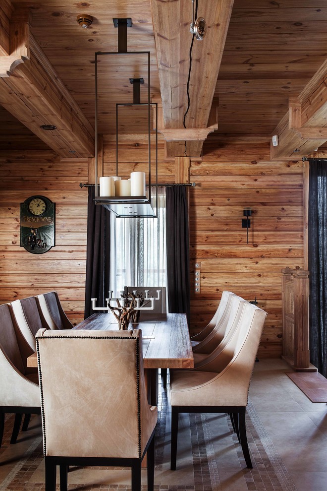 This is an example of a country dining room in Moscow with brown walls.