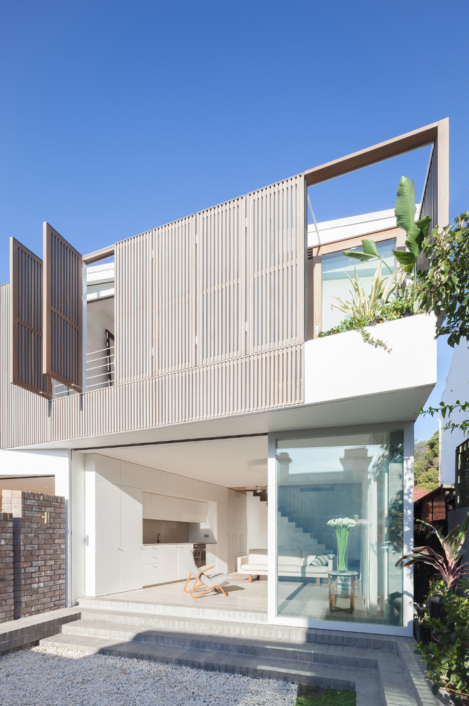 This is an example of a contemporary two-storey stucco white exterior in Sydney with a flat roof.