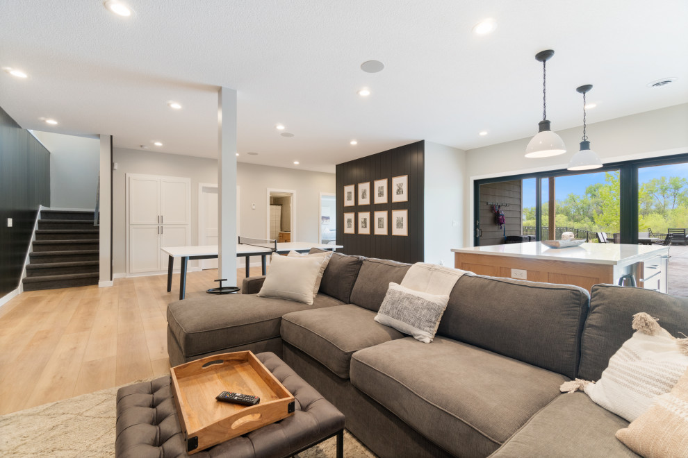Photo of a medium sized modern formal open plan living room in Minneapolis with black walls, vinyl flooring, a wall mounted tv, beige floors and tongue and groove walls.