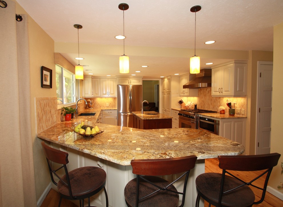 Example of a large transitional u-shaped medium tone wood floor eat-in kitchen design in Denver with an undermount sink, raised-panel cabinets, white cabinets, granite countertops, beige backsplash, ceramic backsplash, stainless steel appliances and an island