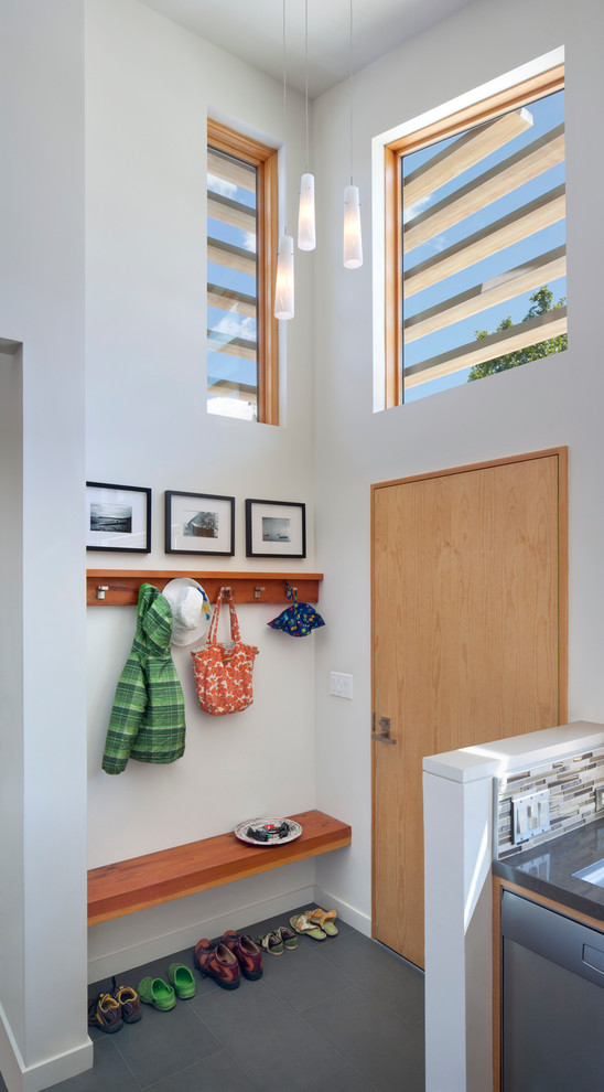 Midcentury entryway in San Francisco with white walls, a single front door and a light wood front door.