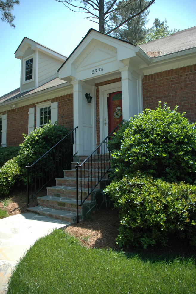 This is an example of a mid-sized traditional front yard verandah in Atlanta.