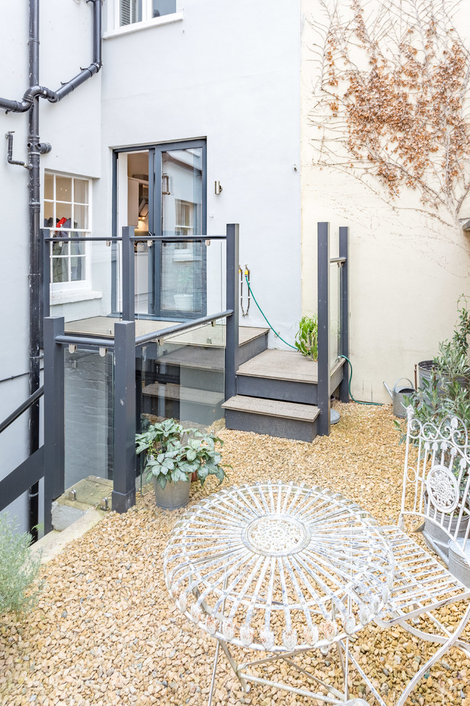 Design ideas for a small contemporary backyard full sun garden in London with gravel.