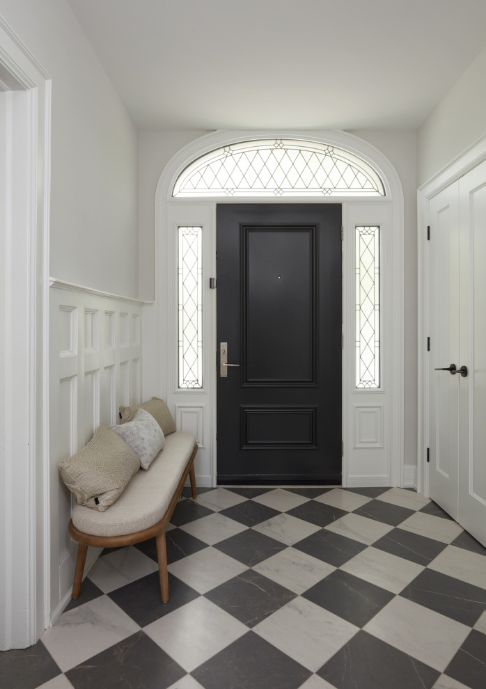 Réalisation d'un hall d'entrée tradition de taille moyenne avec un mur blanc, un sol en carrelage de porcelaine, une porte simple, une porte noire, un sol gris et du lambris.