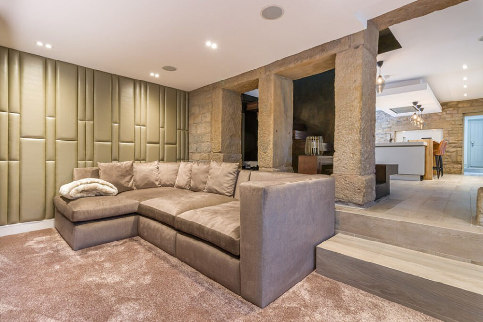 Photo of a large modern formal and grey and brown enclosed living room in London with multi-coloured walls, carpet, a standard fireplace, a concrete fireplace surround, a built-in media unit, beige floors, a wood ceiling, brick walls and feature lighting.