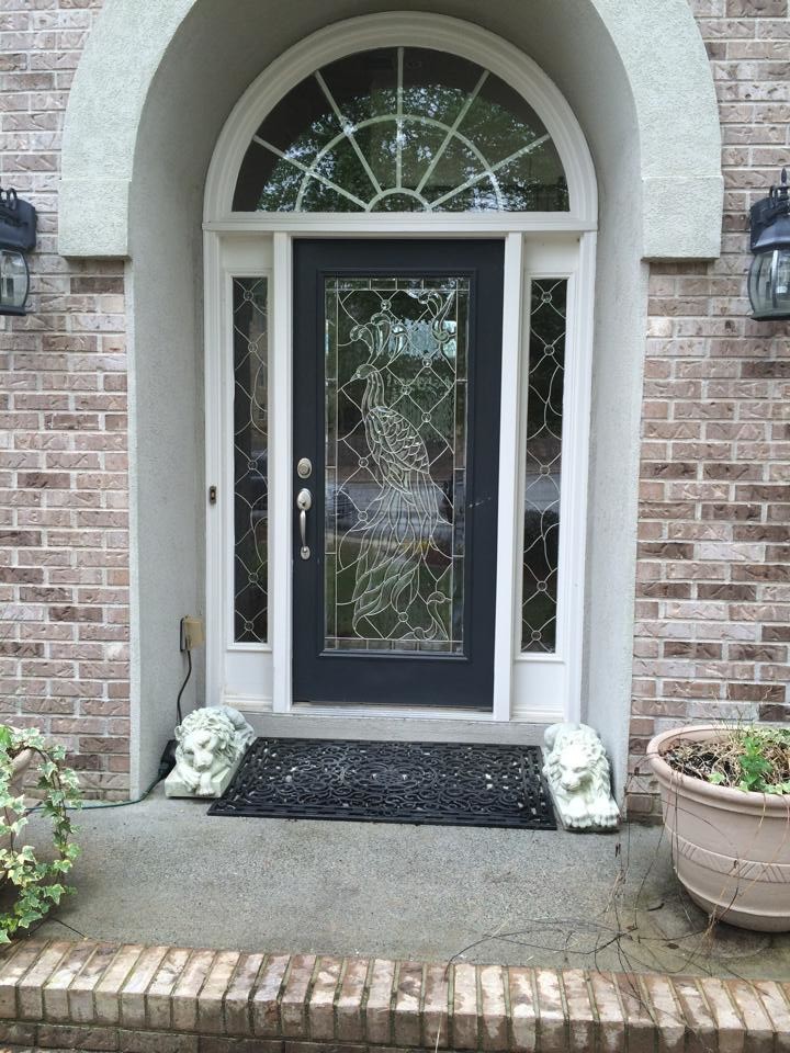 This is an example of a large transitional front door in Atlanta with a single front door and a black front door.