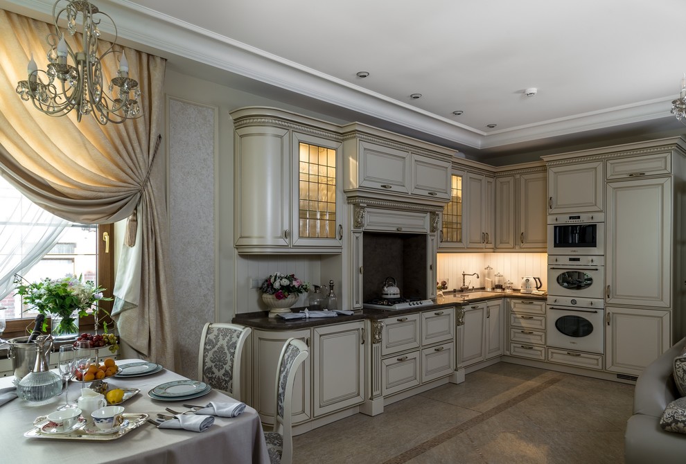 Design ideas for a large traditional l-shaped open plan kitchen in Moscow with raised-panel cabinets, beige cabinets, quartz benchtops, beige splashback, marble splashback, coloured appliances, marble floors, no island and beige floor.