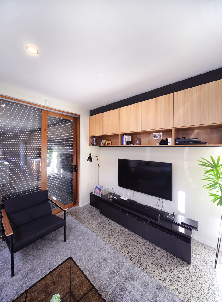 This is an example of a small contemporary formal open concept living room in Melbourne with white walls, concrete floors, a wall-mounted tv and multi-coloured floor.