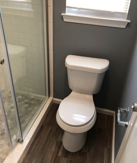 Photo of a small traditional master bathroom in Other with a sliding shower screen, furniture-like cabinets, blue cabinets, a freestanding tub, an alcove shower, a two-piece toilet, grey walls, wood-look tile, an integrated sink, engineered quartz benchtops, brown floor, white benchtops, a single vanity and a freestanding vanity.