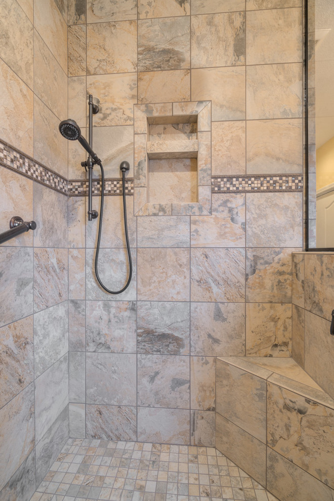 Home design - mid-sized transitional master multicolored tile ceramic tile home design idea with raised-panel cabinets, beige cabinets, a two-piece toilet, beige walls, an undermount sink and quartz countertops