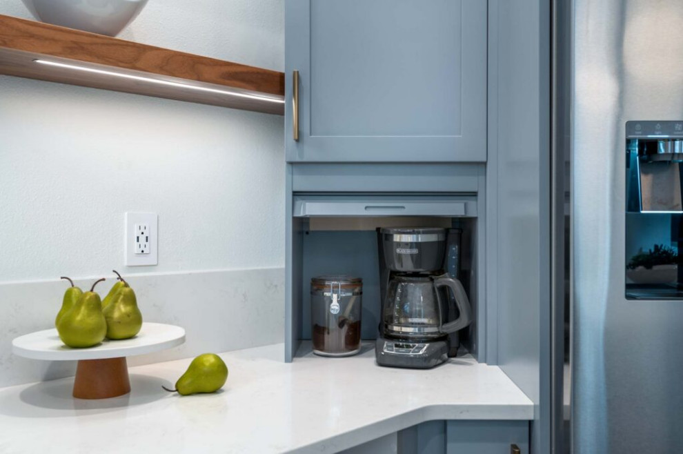 Inspiration for a transitional galley vinyl floor and gray floor kitchen remodel with an undermount sink, shaker cabinets, blue cabinets, quartz countertops, multicolored backsplash, ceramic backsplash, stainless steel appliances, a peninsula and white countertops