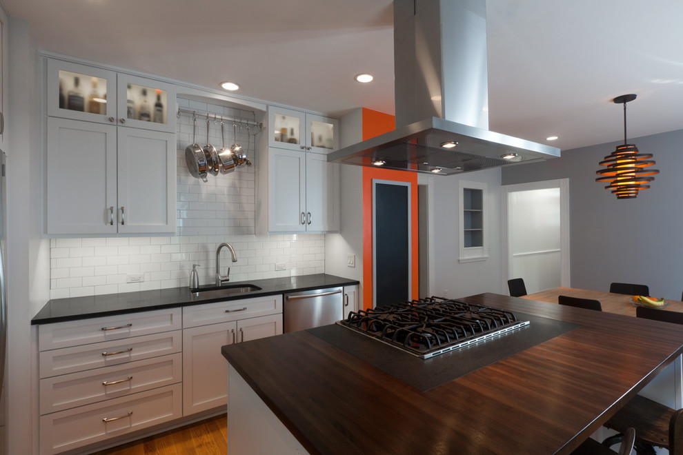 Contemporary eat-in kitchen in Boston with shaker cabinets, subway tile splashback, stainless steel appliances, wood benchtops, a single-bowl sink and white splashback.