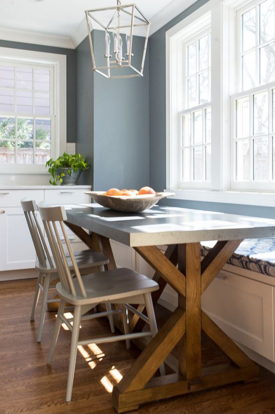 Example of a large transitional l-shaped medium tone wood floor and brown floor open concept kitchen design in Chicago with a farmhouse sink, recessed-panel cabinets, white cabinets, quartz countertops, white backsplash, subway tile backsplash, stainless steel appliances, an island and white countertops