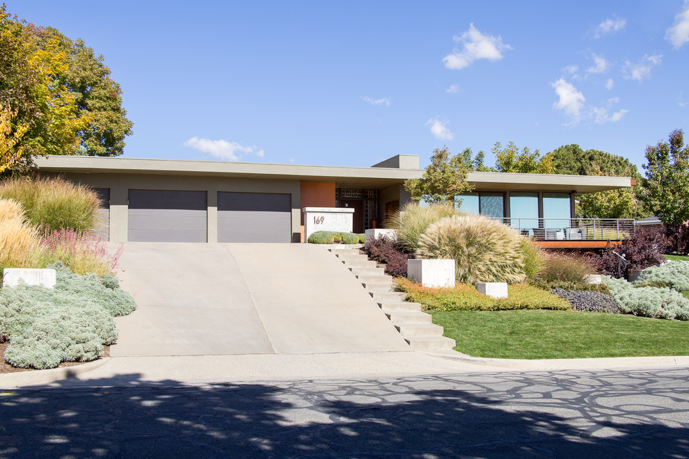 Design ideas for a large midcentury two-storey stucco multi-coloured house exterior in Salt Lake City with a flat roof.